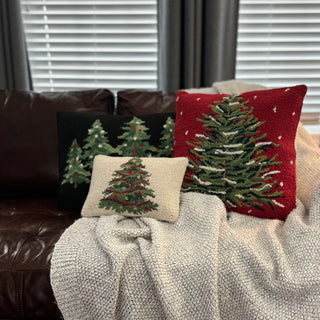 Holiday home decor setup featuring Red Snowy Christmas Tree and festive pillows