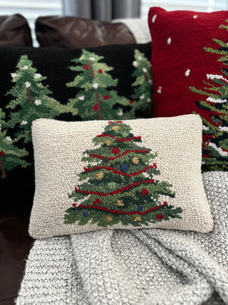 Hand-hooked wool Christmas tree pillow with colorful red pillow background and festive black tree pillow background