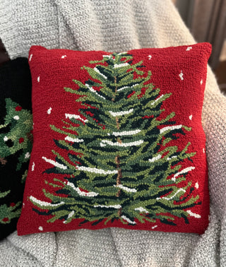 Hand-hooked Red Snowy Christmas Tree Pillow on a cozy blanket