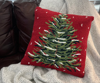 Close-up of detailed snowy evergreen tree design on pillow