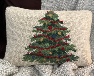 Close-up of wool texture and handcrafted design on holiday-themed pillow.