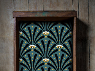 Close up image of art deco eyes peel and stick drawer liner in a vintage drawer